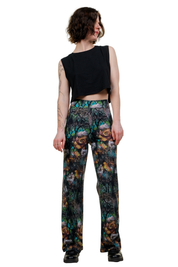 Weite Baumwollhose mit buntem Blumenmuster, getragen von Frau im schwarzen Crop Top